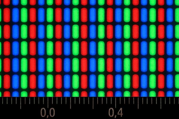 A close-up view of an LCD panel showing the grid of individual red, green, and blue pixels