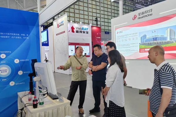 A wide view of the DMHC 2025 show floor with visitors engaging at the Reshin booth.