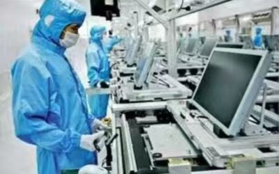 Workers manufacturing and testing medical displays in a cleanroom workshop