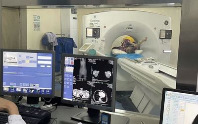 Radiology doctors operating diagnostic displays for CT image analysis in scanning room