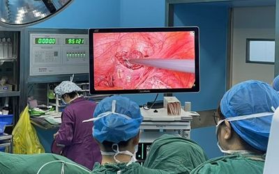 Surgical team using 4K medical display during minimally invasive surgery in operating room