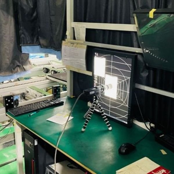Medical display testing workstation with calibration image, camera, and computer equipment
