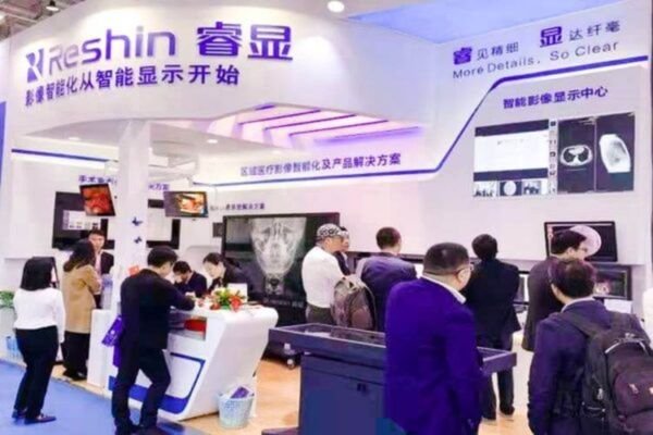 Reshin booth at an international medical exhibition showcasing medical monitors and imaging solutions, attracting numerous visitors.