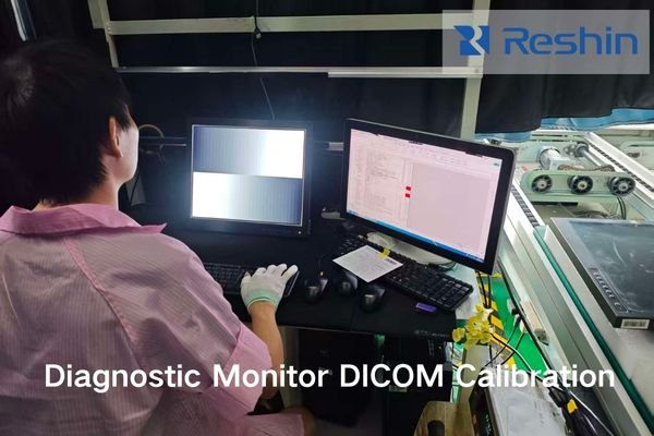 A technician calibrating a mammography diagnostic monitor with a photometer and test pattern on screen.