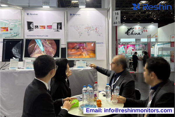 Medical technology exhibition hall showing professional displays, clinical specialists engaging with products, and technical demonstrations in progress.