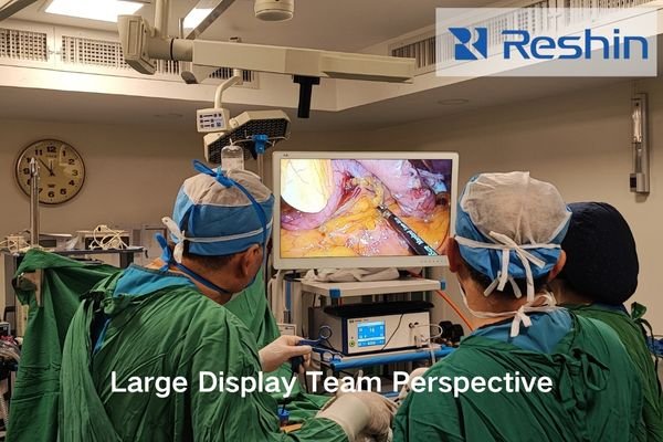 Operating team viewing a large 32-inch surgical display in a hybrid OR.