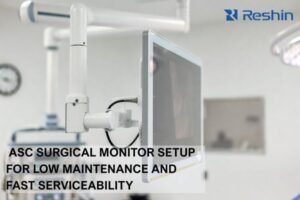 Boom-mounted ASC surgical monitor with sealed cleanable front and strain-relieved cables for reduced maintenance and downtime