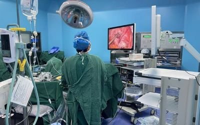 Integrated operating room scene with surgical display showing endoscopic video for OR system integration