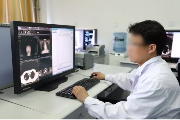 Radiologist reviewing CT and X-ray images on a Reshin medical diagnostic display