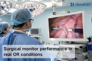 Surgeons viewing a glare-controlled surgical monitor with a clear endoscopic image in a bright operating room