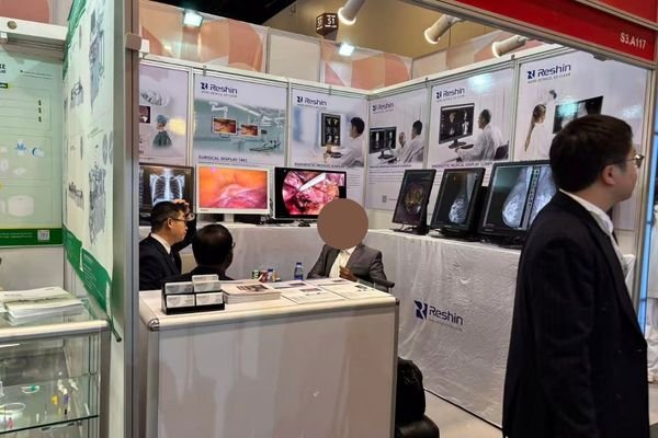 Healthcare decision-makers evaluating medical display technology at regional exhibition