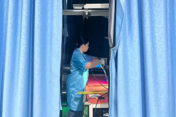 Reshin technician performing signal interface and functional inspection on a medical display