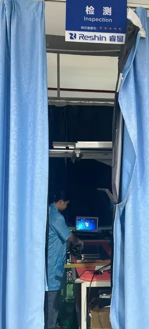 Reshin technician performing signal interface and functional verification on a medical display